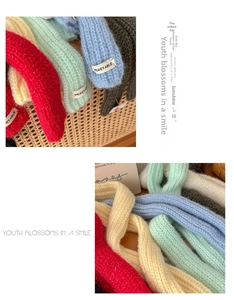 Close-up of knit texture and 'VEGETABLE' label on colorful mohair-style scarves