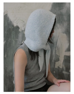 Detail of light blue knit balaclava with cozy mohair texture and integrated scarf wrap