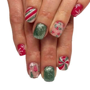 Short Christmas press-on nails featuring festive red snowflakes, green glitter, and candy stripes