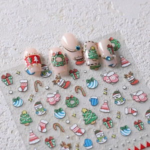 Christmas cartoon nail stickers featuring embossed Santa, snowman, and reindeer designs