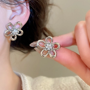 Elegant hollow flower stud earrings with white zirconia center in silver finish for women