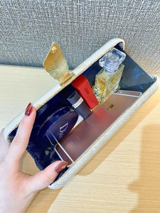 Internal view of the open velvet evening clutch showing space for phone and makeup