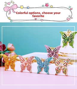 Detail showing variety of colorful butterfly keychains with shimmering crystals and rhinestones