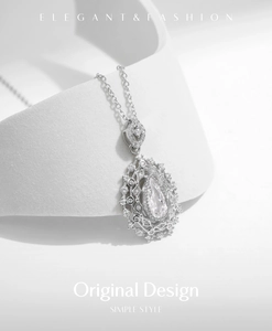 Macro shot of silver teardrop pendant with sparkling diamonds and vintage hollow metalwork