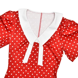 Detail of red vintage polka dot dress with white Peter Pan collar and puff sleeves