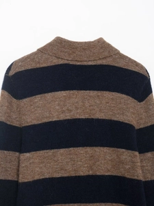 Close-up of mock neck collar and striped wool texture on a brown and navy knit sweater