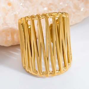 Detailed view of a gold geometric open bangle with vertical wavy hollow patterns