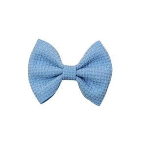 Blue waffle knit bow hair accessory for kids featuring a textured fabric swallowtail design