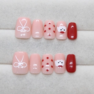 Cute short square press-on nails featuring red polka dots, bows and cartoon dog designs
