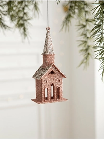 Rose gold and silver glitter church ornament hanging on pine needles with bokeh lights