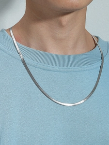 Close-up of a 4mm silver-tone stainless steel snake chain necklace on a male model
