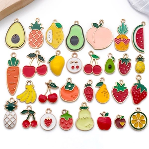 Macro view of 27 assorted colorful enamel fruit and vegetable charms for DIY jewelry making