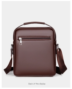 Detail view of the back of a dark brown vintage leather crossbody bag with a zipper pocket