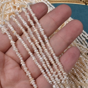 Macro shot of 2.5mm natural white freshwater mini pearl strand for DIY jewelry making