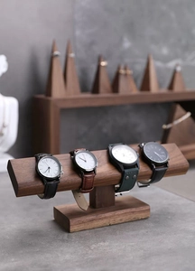 Detailed close-up of dark walnut wood watch stand showing natural grain and texture