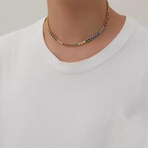 Close-up of colorful heart-shaped cubic zirconia stones on a gold-plated tennis necklace