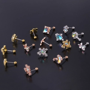 Detailed close-up of surgical steel stud earrings featuring iridescent moonstones and gems