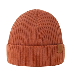Detailed view of caramel ribbed knit beanie with a minimalist leather patch detail