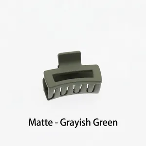 Detail of matte grey-blue square hollow hair claw clip with strong spring and comb teeth