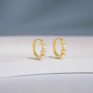 Macro shot of gold-plated S925 sterling silver earring with white zircon inlay