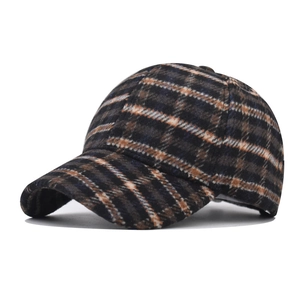 Close-up of thick houndstooth plaid baseball cap showing wool-like texture and weave