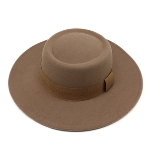 Detail of light brown wool felt wide brim boater hat with flat top and matching band