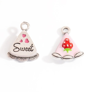 Detail of sweet cake slice pendants with pink enamel hearts and strawberry motifs