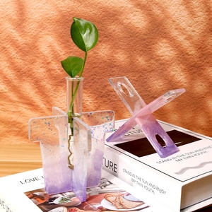 Close-up of modern gradient acrylic hydroponic vase with glitter and glass tube