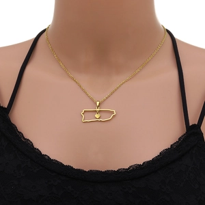 Detail of gold Puerto Rico map pendant with heart charm on black lace clothing