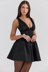Close-up of black satin mini dress featuring a deep V-neck and structured corset waist detail