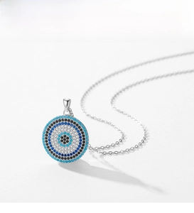 Macro detail of Turkish Evil Eye pendant with pavé multi-color crystals on silver chain