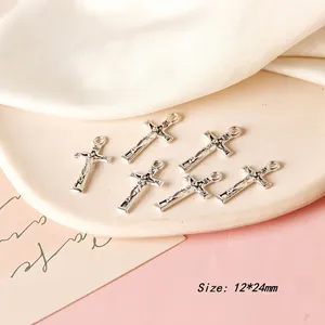 Macro shot of vintage alloy cross charms measuring 12x24mm for DIY jewelry making