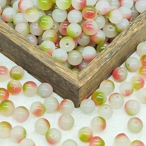 Close-up of 10mm gradient glass beads in a wooden box for DIY jewelry making