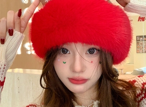 Close-up of fuzzy red faux fur headband with soft texture and festive winter style