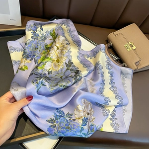 Lilac floral silk scarf with peony patterns and vintage border held by hand