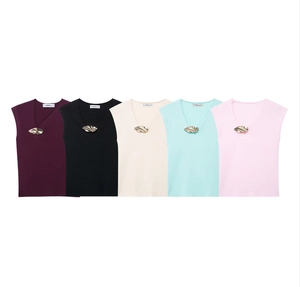Close-up of sleeveless knit tops featuring V-neckline and decorative gold textured metal buttons