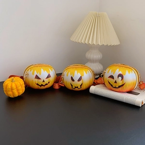 Detailed view of three pumpkin-shaped bags with varied expressions and gold metal chains