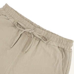 Detail of men's linen shorts showing elastic waistband, adjustable drawstring and pockets