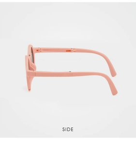 Side view of foldable pink matte children's sunglasses showing hinge detail