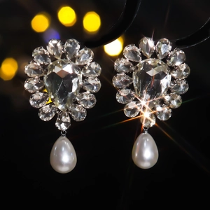 Luxury silver stud earrings featuring teardrop pearls and sparkling crystal flower clusters