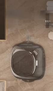 Brown transparent washbasin hanging on a wall hook for space-saving bathroom storage