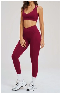 Dettaglio dei leggings da yoga bordeaux con design a vita incrociata e tasca laterale