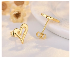 Macro detail of 18K gold plated hollow heart studs with S925 sterling silver pins