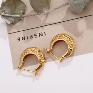 Elegant 18K gold plated hoop earrings featuring embossed heart texture on a warm aesthetic backdrop