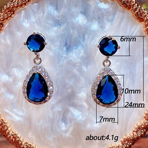 Elegant teardrop blue zircon earrings with silver plated finish and 24mm drop length