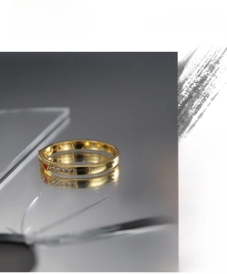 Detail of gold heart ring with red enamel and sparkling cubic zirconia stones