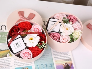 Detailed view of pink round gift box with soap roses, carnations and a scented candle