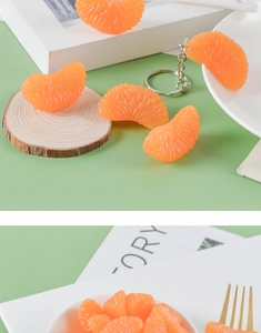 Close-up of realistic PVC orange slice keychain with detailed pulp texture and metal ring