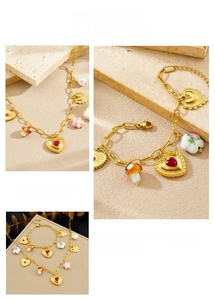 Detailed view of gold chain jewelry set featuring mushroom, heart, and pearl charms