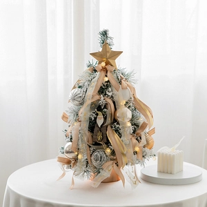 Mini snow-flocked Christmas tree with LED lights and golden star for tabletop decor